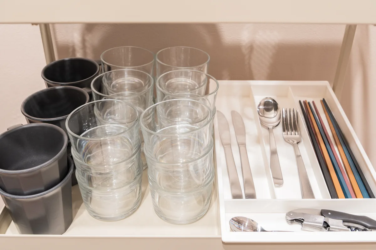 Glassware and cutlery ready in the kitchen drawer