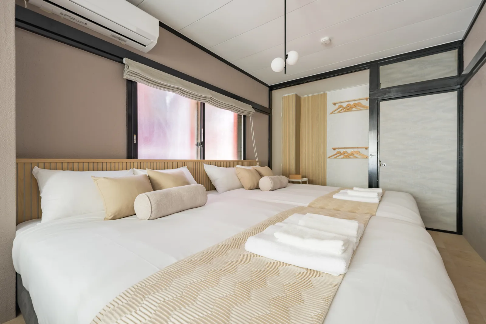 A bedroom in 201, daylight through a wide window
